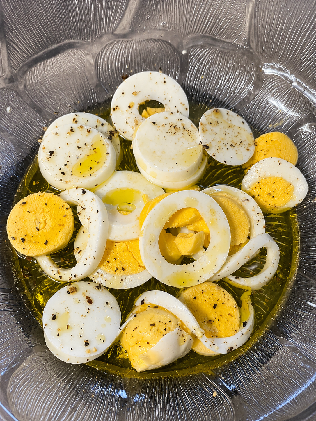 First layer of potato tuna and egg salad in serving dish