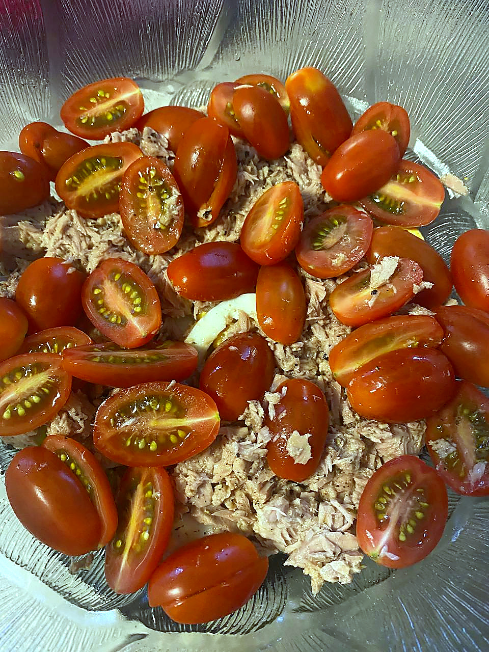 Finished tuna egg and potato salad topped with tomato and parsley